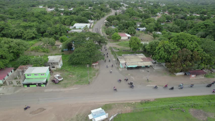 Motorcycle caravan riding through scenic countryside, South America adventure