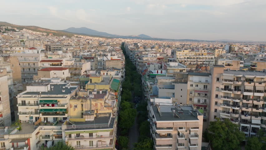 Thessaloniki, Greece, showcases its vibrant urban landscape from above. Tsimiski Street, bustling with activity, runs through the city, lined with various shops and businesses