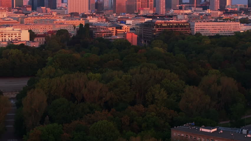 Modern skyscrapers are standing out in the Warsaw skyline, bathing in the warm light of the setting sun in the Capital City of Poland
