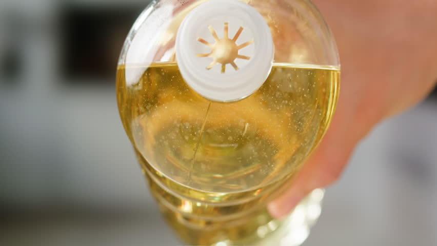 Pouring olive linen oil sunflower in different dishes close-up. Using in cooking for frying foods or as a salad dressing omega 3. Olive oil is popular supplement for meals and salads. 