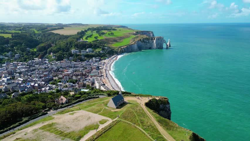 Aerial view of Etretat cliffs on the Normandy coast in France, with dramatic white chalk formations, natural arches, and the deep blue sea, a famous landmark for nature, travel, and adventure photo
