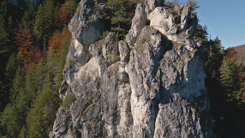 Fly-Up Over Rocky Cliff in Colorful Autumn Mountains Forest