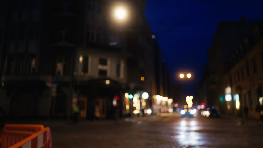 A picturesque nighttime city street scene featuring blurred traffic lights and a captivating ambient glow