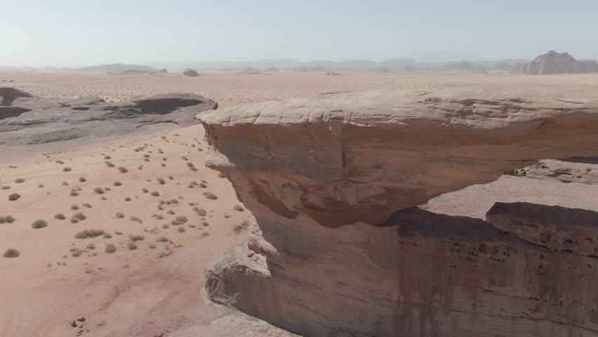 Unique aerial drone footage of an unusual rock formation in Northern Saudi Arabia. Stunning natural landscape with dramatic shapes and desert scenery.
