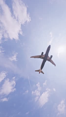 Airplane flying close overhead coming in to land in barcelona airport in vertical