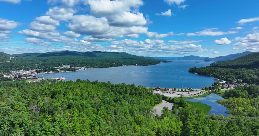Lake George, New York, USA - July 22, 2025: Afternoon aerial summer video of the area surrounding the Lake George, NY,	Dolly backwards, reverse movement 