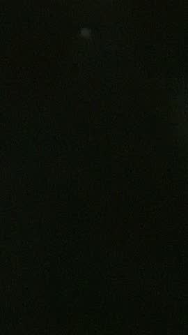 Vertical video. Fireworks on the beach celebrating the end of the fiesta. High-flying, powerful, single charges explode in the sky. Mallorca, Spain.