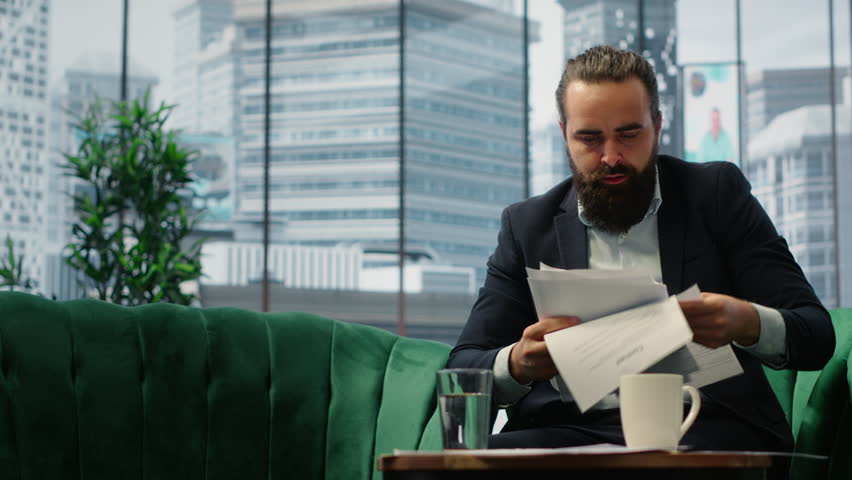 Worried entrepreneur in despair struggling with too much paperwork, working under stress after financial crisis and business failure. CEO feeling the weight of corporation downfall. Camera A.