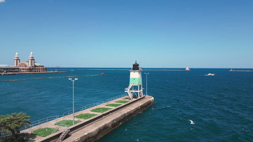 Aerial of Chicago shoreline lighthouse with Lake Michigan in the background. 