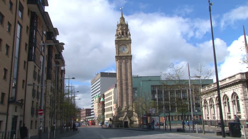 A clock tower striking 12 times at midday.