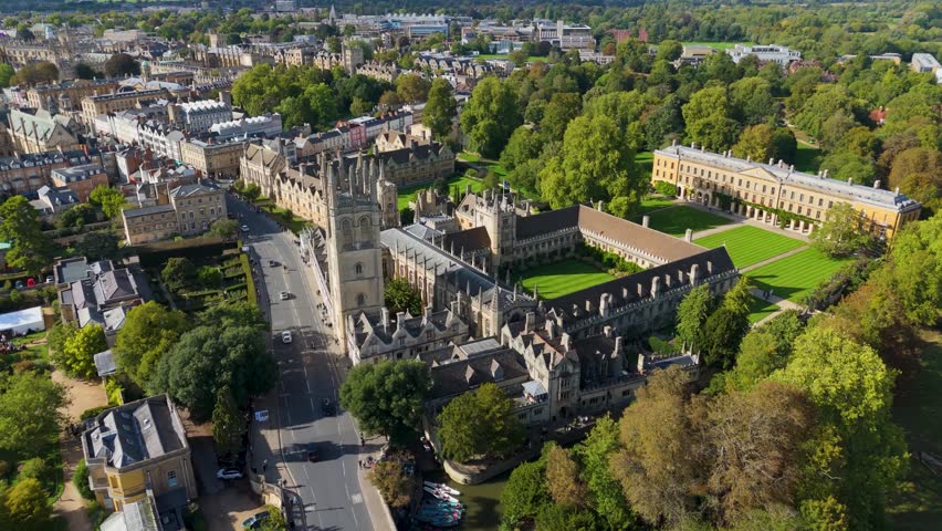 Aerial drone flight towards Magdalen College, Oxford. Camera tilts down, revealing the medieval courtyard, Gothic spires, and historic architecture of one of Oxford’s most iconic university colleges.