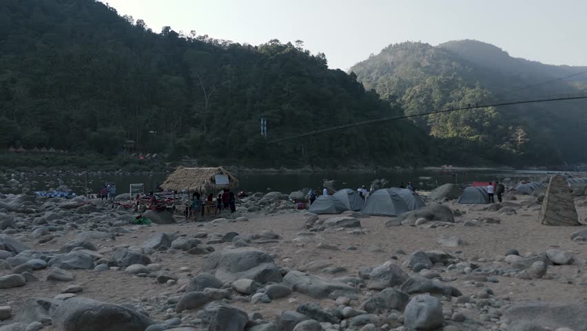 Aerial view of the suspension bridge and clear Umngot River in Shnongpdeng village, a tourist destination in Meghalaya, India.