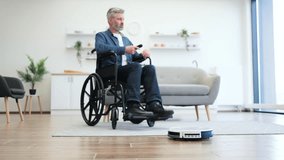 Senior man in wheelchair cleaning modern living room floor using robot vacuum, emphasizing independence aided by technology and innovation, reflecting concepts of smart home, accessibility - Powered by Shutterstock - Get 15% off with code: PIKWIZARD15