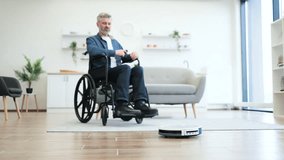 Senior man in wheelchair cleaning modern living room floor using robot vacuum, emphasizing independence aided by technology and innovation, reflecting concepts of smart home, accessibility - Powered by Shutterstock - Get 15% off with code: PIKWIZARD15