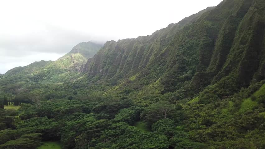 Drone wide shot of green mountains at ho