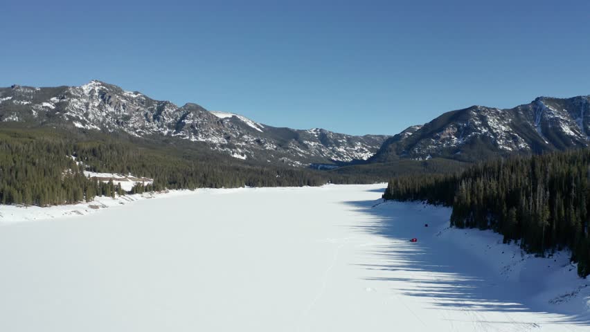Montana winter, aerial over snow covered Frozen Lake nature national park America