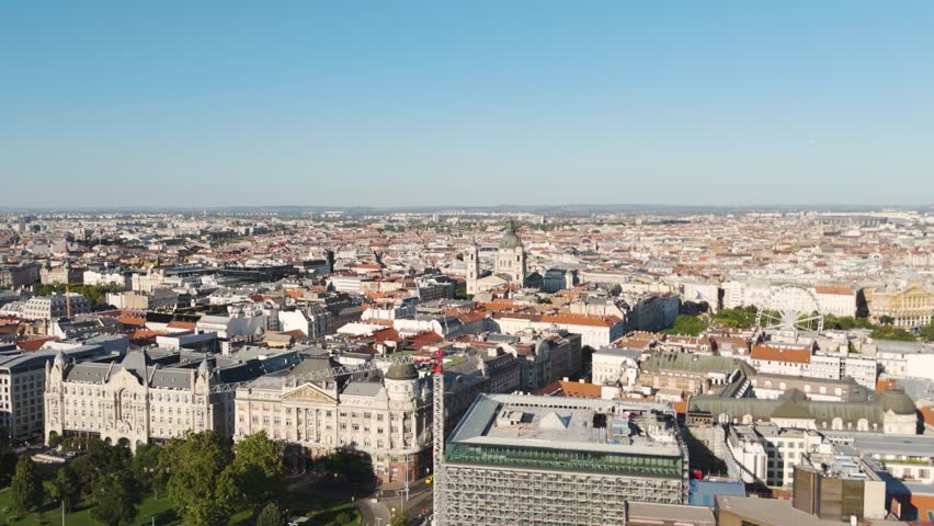 Aerial of St. Stephen’s Basilica, highlighting its iconic architecture against Budapest’s historic cityscape from a distant vantage point