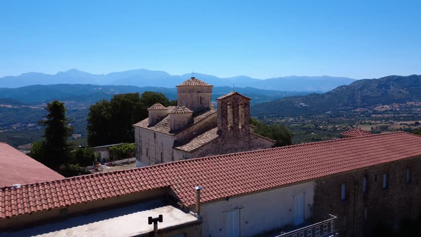 Byzantine Orthodox stone church with domes and bell tower in Greece