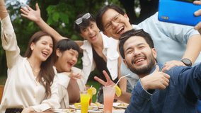 Group of Happy Asian people diverse friends using mobile phone taking selfie together while celebration social gathering meeting dinner party eating food, drinking cocktail in the garden in evening. - Powered by Shutterstock - Get 15% off with code: PIKWIZARD15
