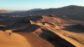 Cinematic drone view of the southern desert, highlighting sweeping dune crests and endless arid terrain. - Powered by Shutterstock - Get 15% off with code: PIKWIZARD15