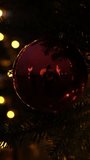 Christmas ornament on tree with warm bokeh of sparkling holiday lights. Cozy festive atmosphere, soft glow, and magic of winter holidays. For Christmas projects, greetings, seasonal advertising. - Powered by Shutterstock - Get 15% off with code: PIKWIZARD15