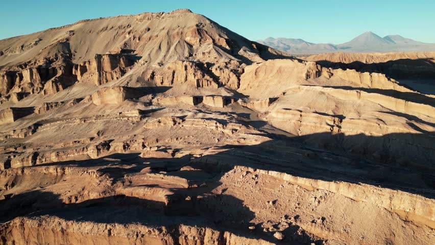 Cinematic drone footage of dramatic rock structures in Valle de la Luna, evoking an extraterrestrial desert environment.