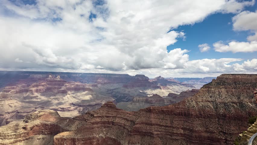 Moving time lapse of the Grand Canyon national park with blue sky and big clouds over wide landscape
