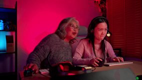 Happy grandmother playing games with grandchild in a neon lit room - Powered by Shutterstock - Get 15% off with code: PIKWIZARD15