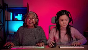 Happy grandmother playing games with grandchild in a neon lit room - Powered by Shutterstock - Get 15% off with code: PIKWIZARD15