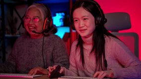 Happy grandmother playing games with grandchild in a neon lit room - Powered by Shutterstock - Get 15% off with code: PIKWIZARD15