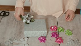 Hands decorating gift box with festive bows - Powered by Shutterstock - Get 15% off with code: PIKWIZARD15