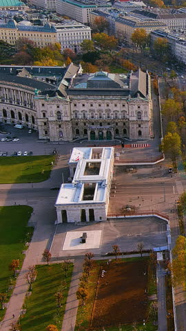 Vertical 4K drone video Vienna State Opera House with modern Albertina Museum and autumn Ringstrasse. Stunning aerial footage of cultural landmarks blending old and new for mobile video platforms.