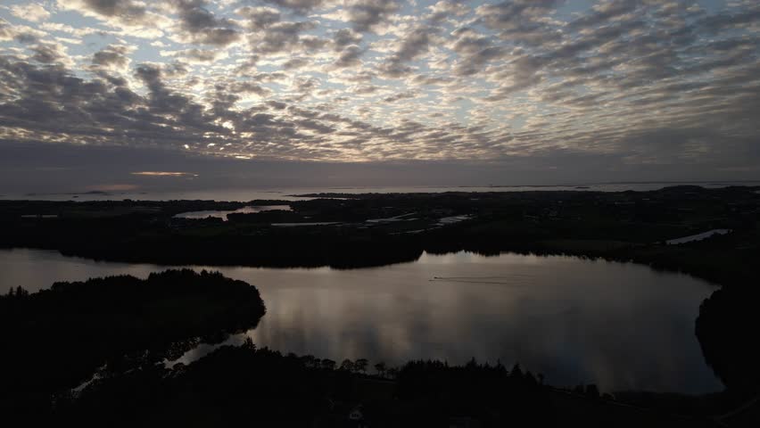 Drone Aerials Over a Lake at Sunset with Spotty Clouds in Stavanger, Norway