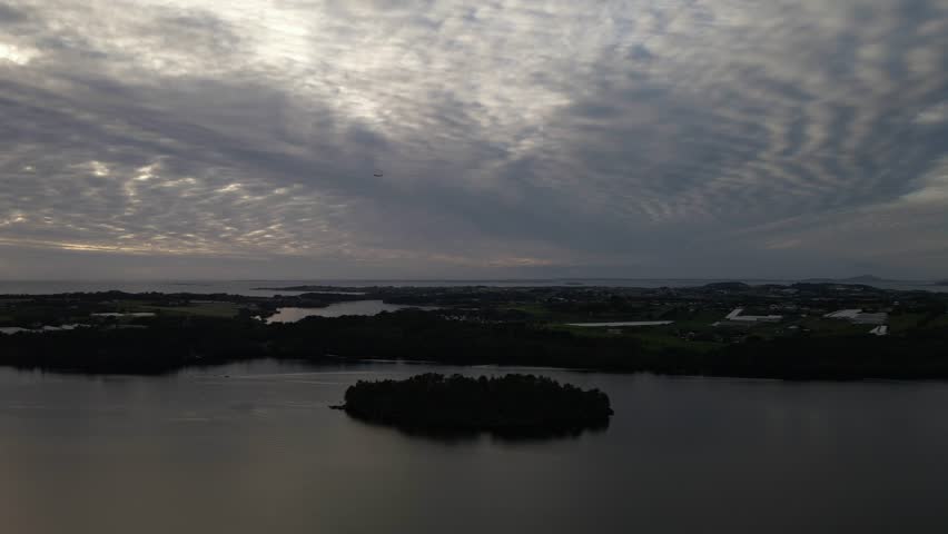 Drone Aerials Over a Lake at Sunset with Spotty Clouds in Stavanger, Norway