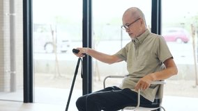 Elderly Asian man standing up with a cane - Powered by Shutterstock - Get 15% off with code: PIKWIZARD15