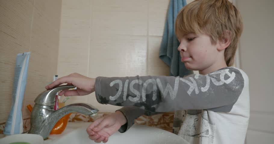 Boy Brushes Teeth in Bathroom in the Morning. 4K 10-bit