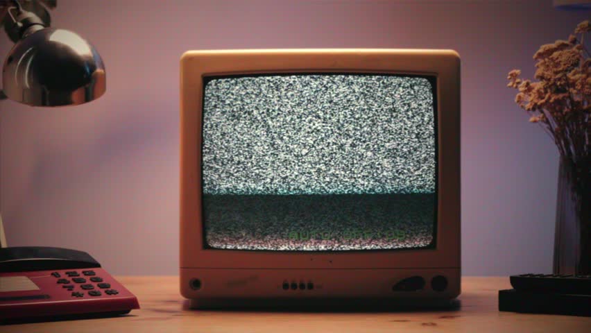 Retro TV, vintage television In a nostalgic setup, a retro TV displays grain on screen, scary halloween night device good for chroma key and green screen.