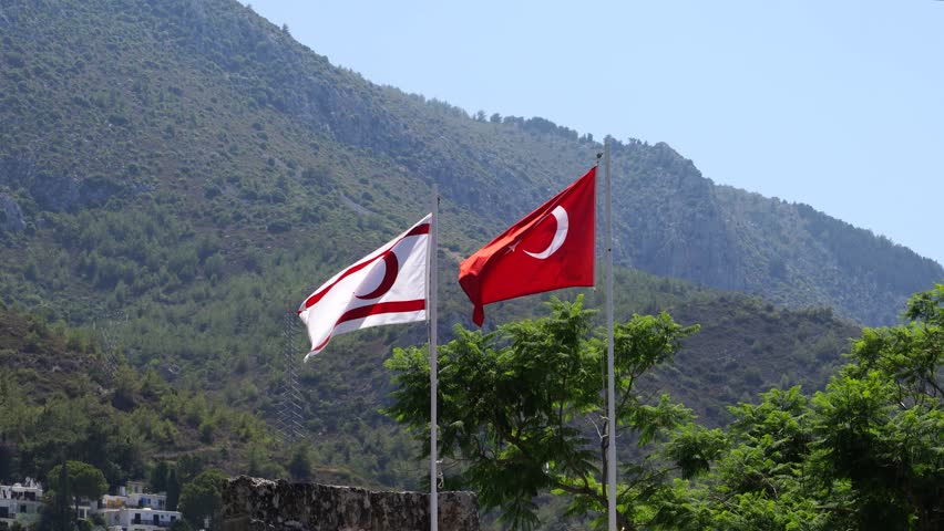 Flags of Turkey and Northern Cyprus are waving over Bellapais Abbey, North Cyprus