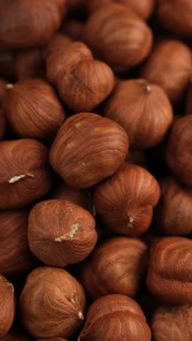 Heap of peeled hazelnuts close up, rotation