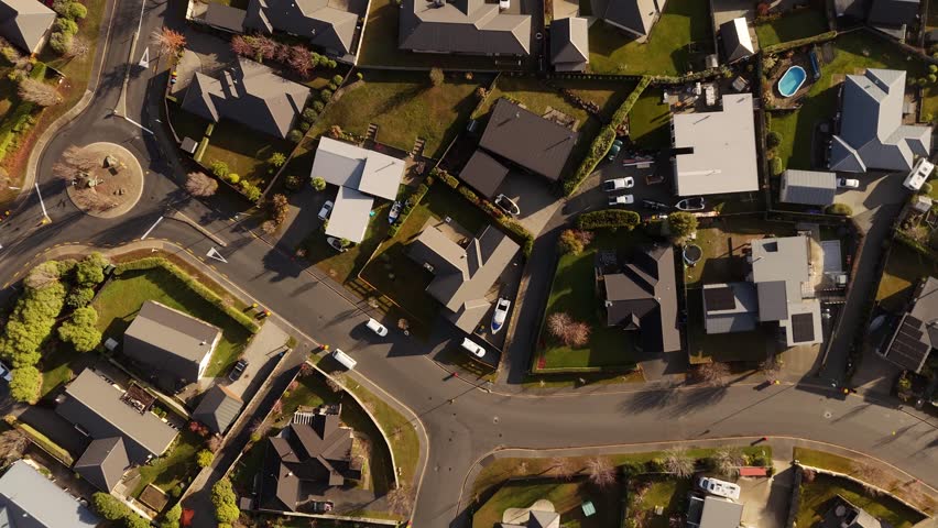 Residential neighborhood in Wanaka, houses and streets, New Zealand. Aerial top-down view