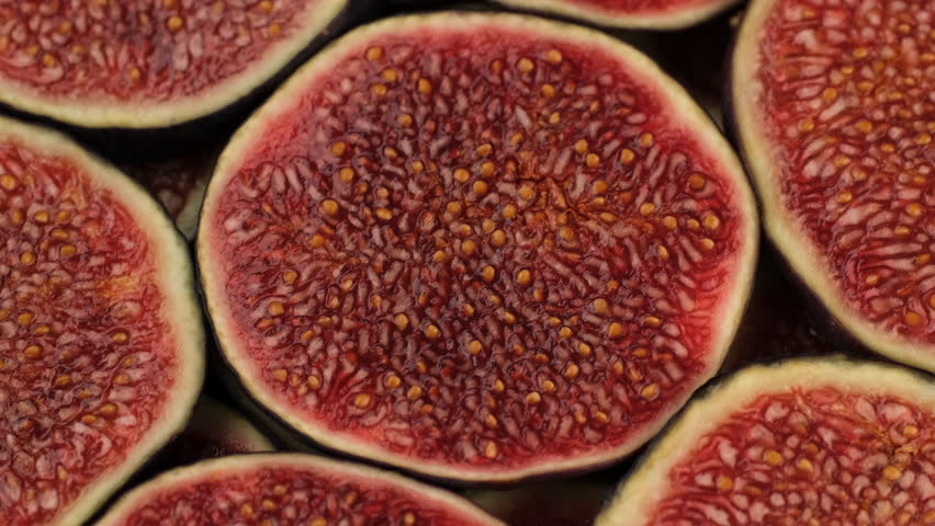 Slices Ripe figs on plate, rotation. Healthy breakfast, natural dessert, juicy organic fig