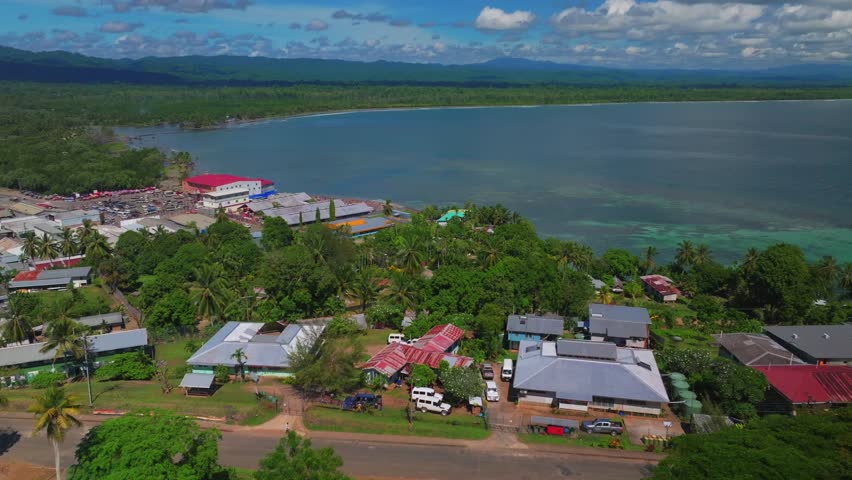 Wewak Hill cars buildings village Boram road Wewak Papua New Guinea aerial drone downtown coastal town Sundaun Market Dogreto Bay Cape Wom Bismark Sea sunny blue sky morning circle right motion