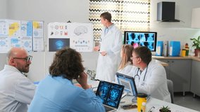 Healthcare professionals in white coats gathered at a seminar. Doctor explains biohacking concepts with pointer, showing brain diagrams and medical illustrations on board. Audience listens attentively - Powered by Shutterstock - Get 15% off with code: PIKWIZARD15