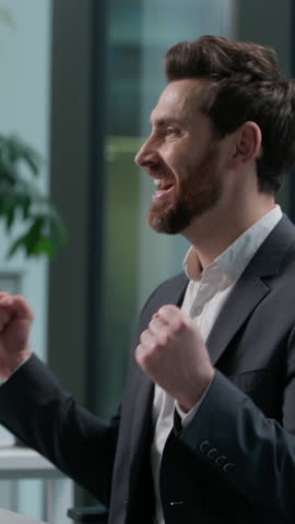 Happy Caucasian adult man working with computer pc reading good news victory winner male winning employee guy business joyful businessman success manager office worker win executive achieve celebrate