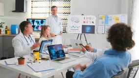 Doctors and interns participate in a hospital seminar. Lecturer uses a pointer to highlight brain diagrams and charts about biohacking. Participants watch during the educational session.  - Powered by Shutterstock - Get 15% off with code: PIKWIZARD15