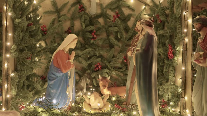 Illuminated Christmas nativity scene with Mary Joseph baby Jesus and animals