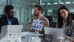 Caucasian businessman team leader talking employees showing graph chart report business presentation men women diverse multicultural group coworkers partners in office females males meeting briefing - Powered by Shutterstock - Get 15% off with code: PIKWIZARD15