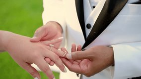 The groom puts on the wedding ring on the bride finger, at the wedding ceremony.  - Powered by Shutterstock - Get 15% off with code: PIKWIZARD15