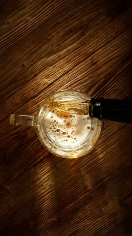 Super Slow Motion of Pouring Beer into Pint Glass, Top Down View. Filmed on High Speed Cinema Camera, 1000 fps.