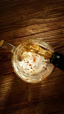 Super Slow Motion of Pouring Beer into Pint Glass, Top Down View. Filmed on High Speed Cinema Camera, 1000 fps.